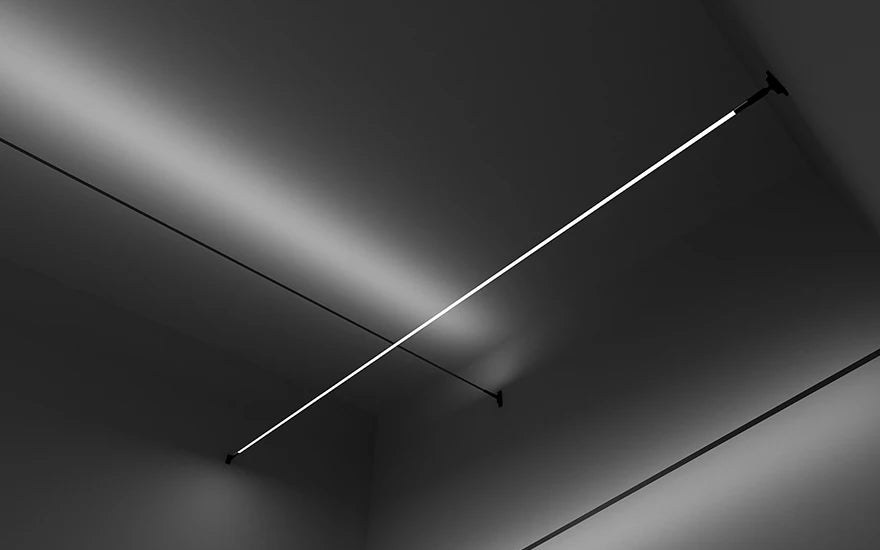 Close-up of A Stream of Light Suspension Light showing the sleek black steel profile and soft linear illumination, architectural suspended lighting from Domus Collective.