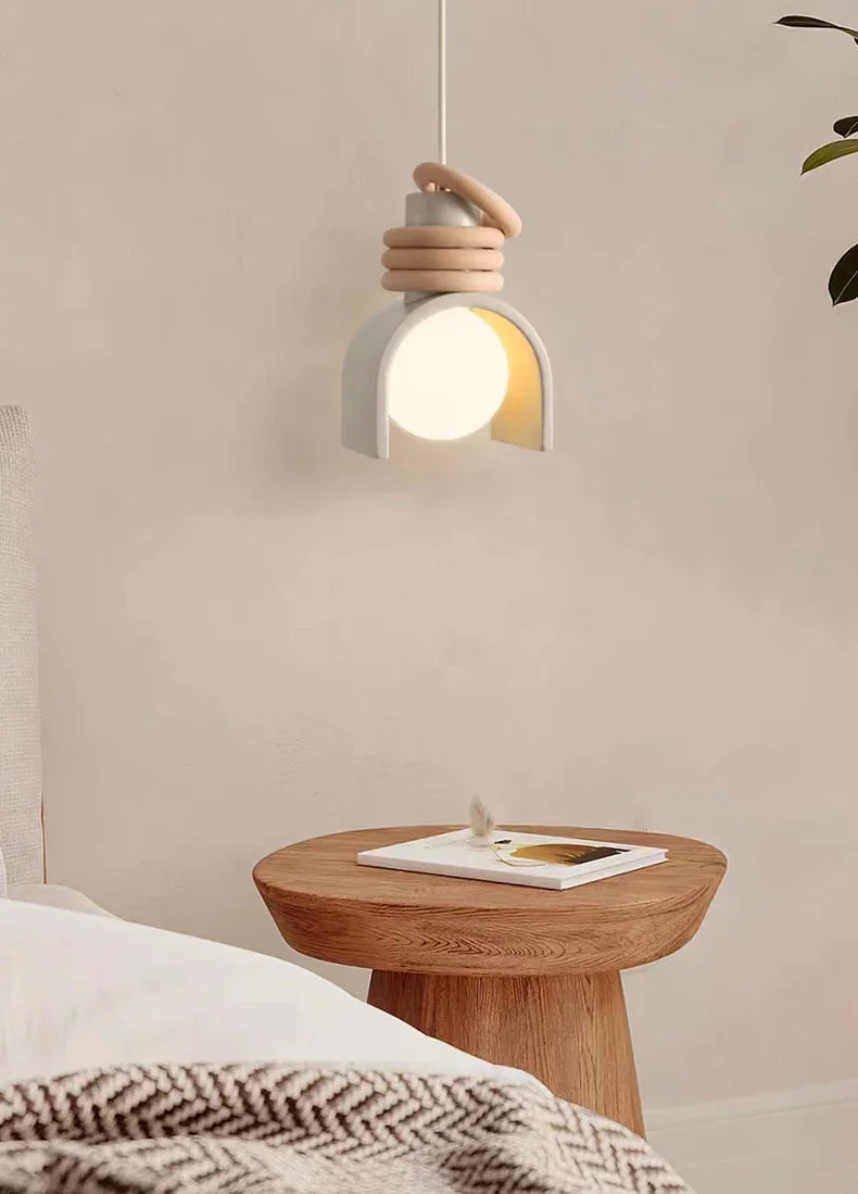 Domus Collective Arc of Calm Pendant Light in soft grey ceramic finish bringing wellness-focused warmth to a serene Scandinavian bedroom setting.