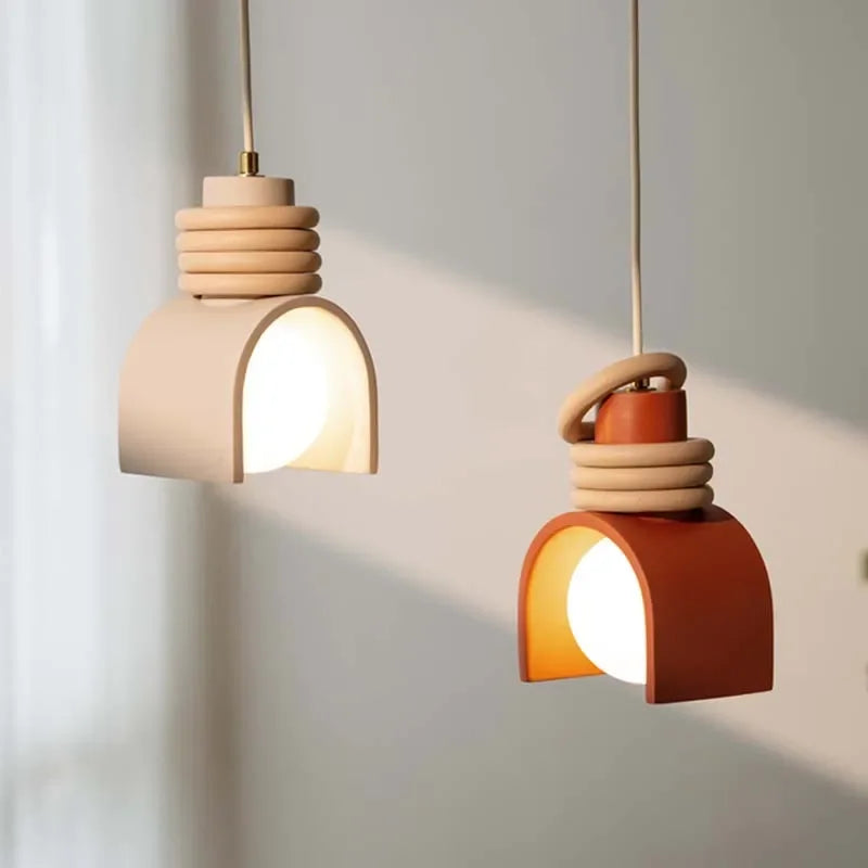 Characterful pairing of Arc of Calm Pendant Lights in nude and burnt sienna tones with organic stacked rings catching natural light,by Domus Collective pendant lights.