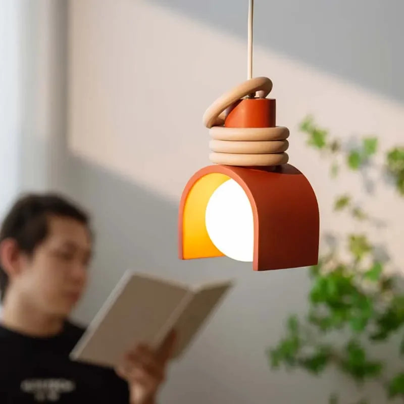 Arc of Calm Pendant Light in warm terracotta with stacked ceramic rings creating soulful ambient glow for contemporary reading nooks,Domus Collective Organic Accents collection.