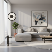 Aura Abstraction Floor Lamp by Domus Collective with circular luminous diffuser and sleek black aluminum frame creating serene ambient glow in minimalist living room, sculptural lighting for contemporary Australian interiors.
