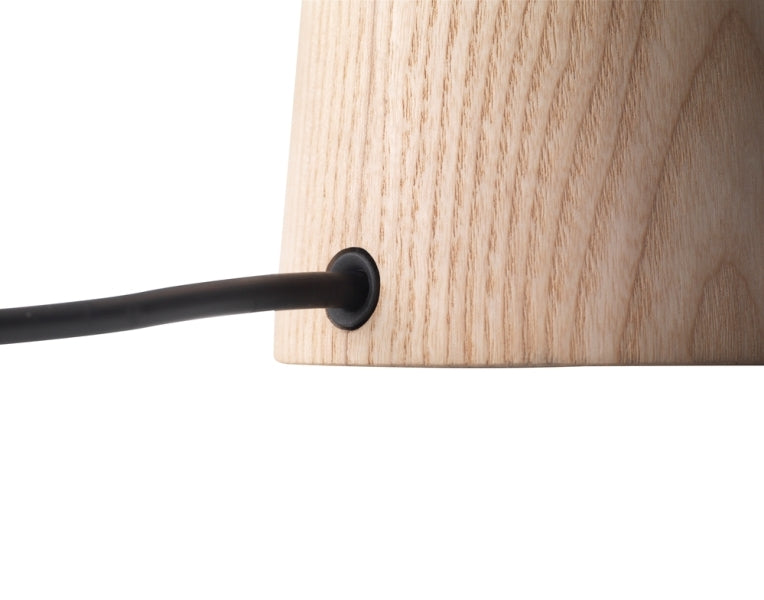 Close-up of the Capella Table Lamp's natural ash wood base with integrated black power cord, demonstrating the clean cable management and quality timber grain finish by Domus Collective.