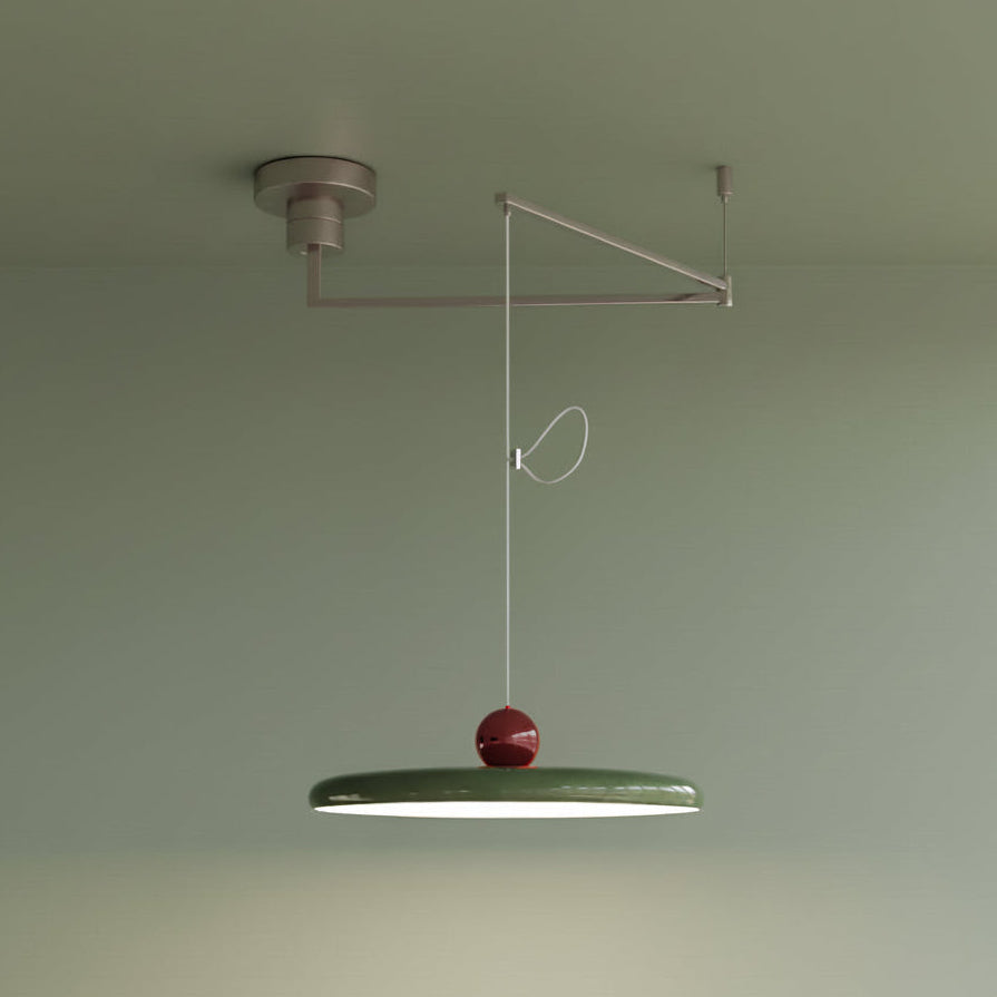 Two-tone Cirra Pendant Light combining sage green disc shade with burgundy chrome sphere accent and nickel swing arm, offering playful color contrast for eclectic interior design schemes.