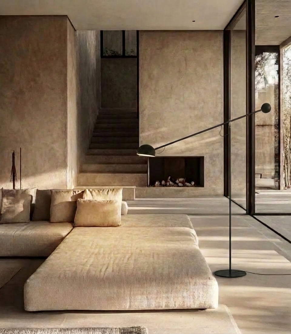 In a sun-drenched brutalist living space with concrete walls and linen sectional, the all-black Dynamic Equilibrium Floor Lamp brings kinetic visual interest through its perfectly balanced cantilevered form, by Domus Collective.