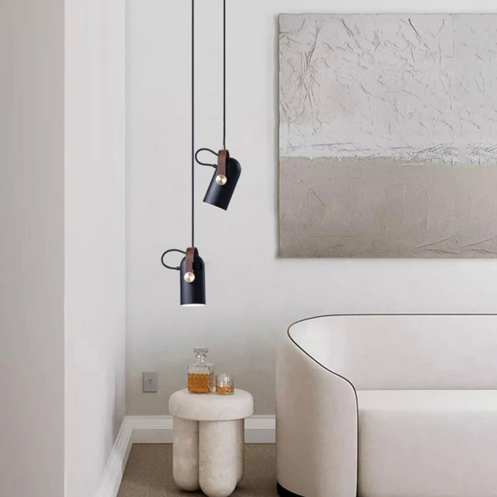 Staggered Film Projector Pendant Light pair with directional black shades and leather details, handcrafted pendants casting focused glow in sophisticated living areas, by Domus Collective.