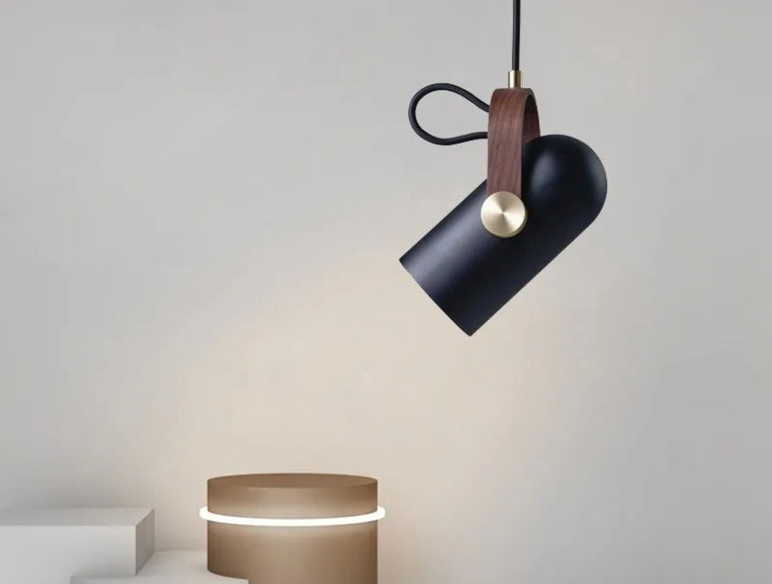 Film Projector Pendant Light in matte black with walnut leather strap and brushed brass pivot, cinema-inspired adjustable pendant adding nostalgic elegance to modern interiors, by Domus Collective.