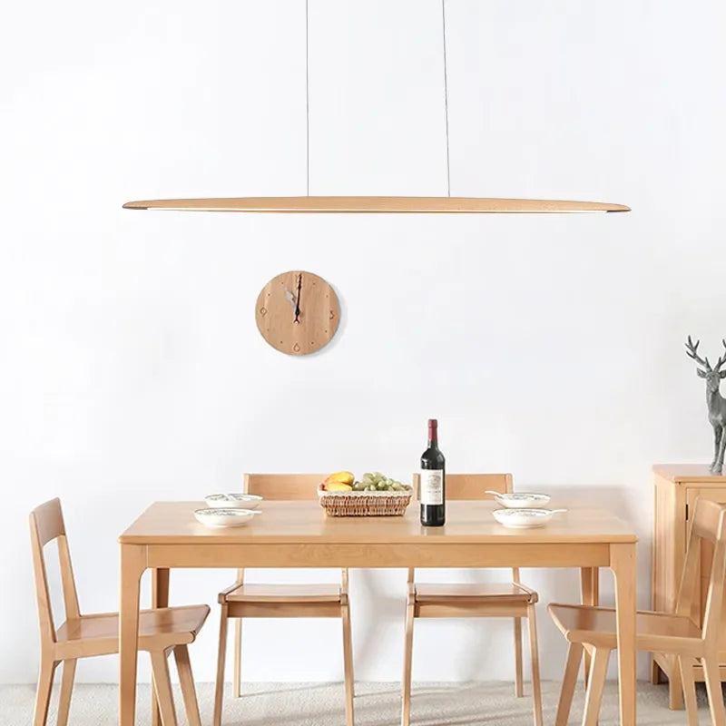 Float Board Pendant Lamp in natural oak finish with surfboard-inspired silhouette, handcrafted wooden linear pendant bringing organic warmth to Scandinavian dining spaces, by Domus Collective.