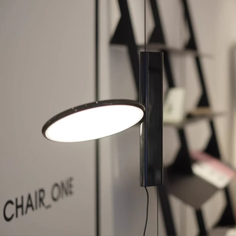 Close-up of the Floating Disc  Suspension Lights showcasing its slim rectangular stem and tilted circular LED panel in polished black finish, precision engineered by Domus Collective.