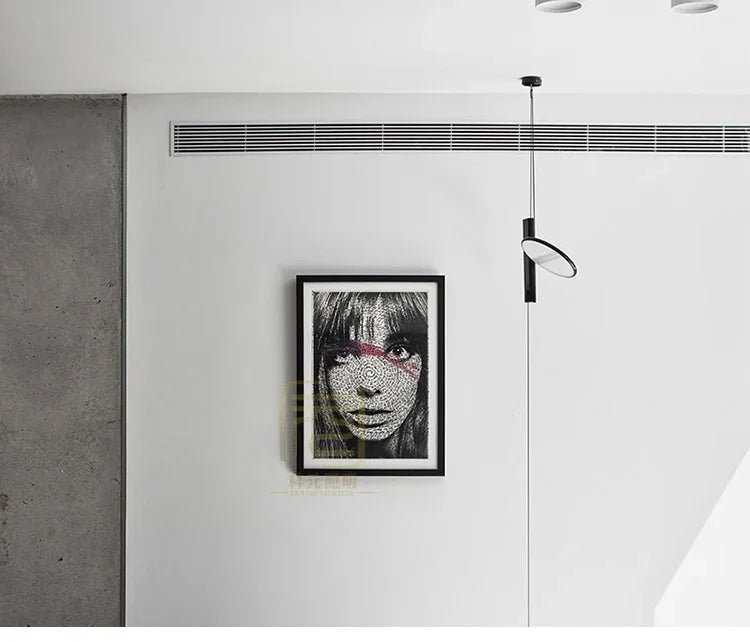 Sleek black Floating Disc  Suspension Lights suspended in a modern gallery-style interior with concrete accents, statement lighting by Domus Collective.