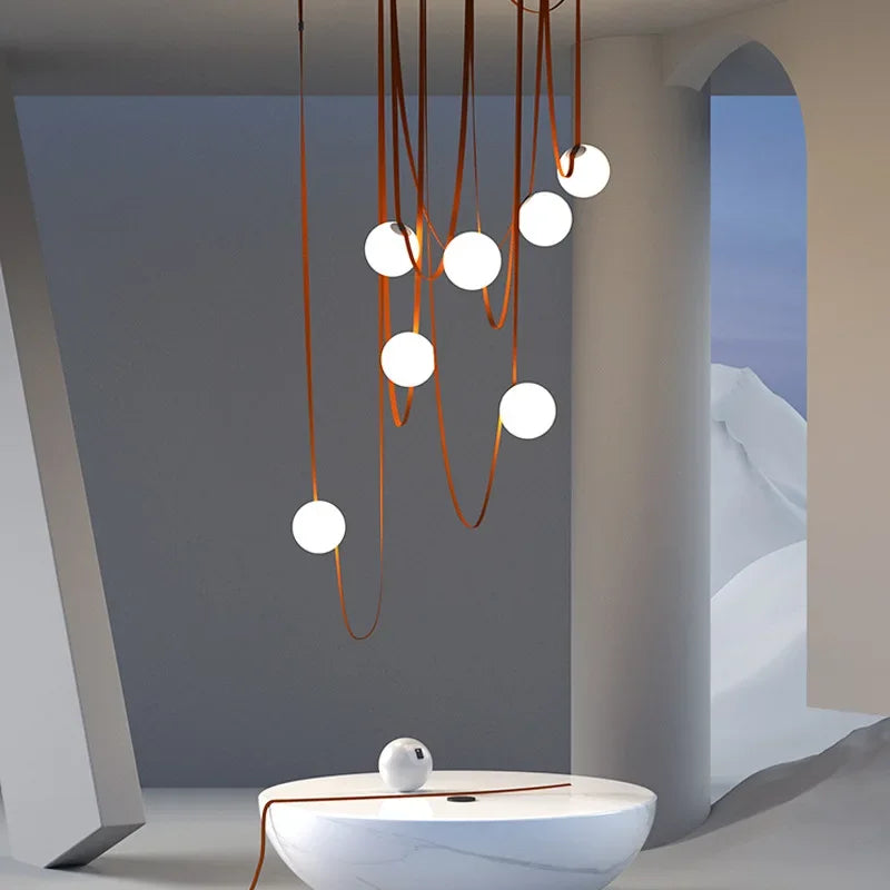 Floating Moons Pendant Light featuring frosted glass orbs suspended on terracotta leather cords, sculptural celestial chandelier casting ambient glow in architectural interiors, by Domus Collective.
