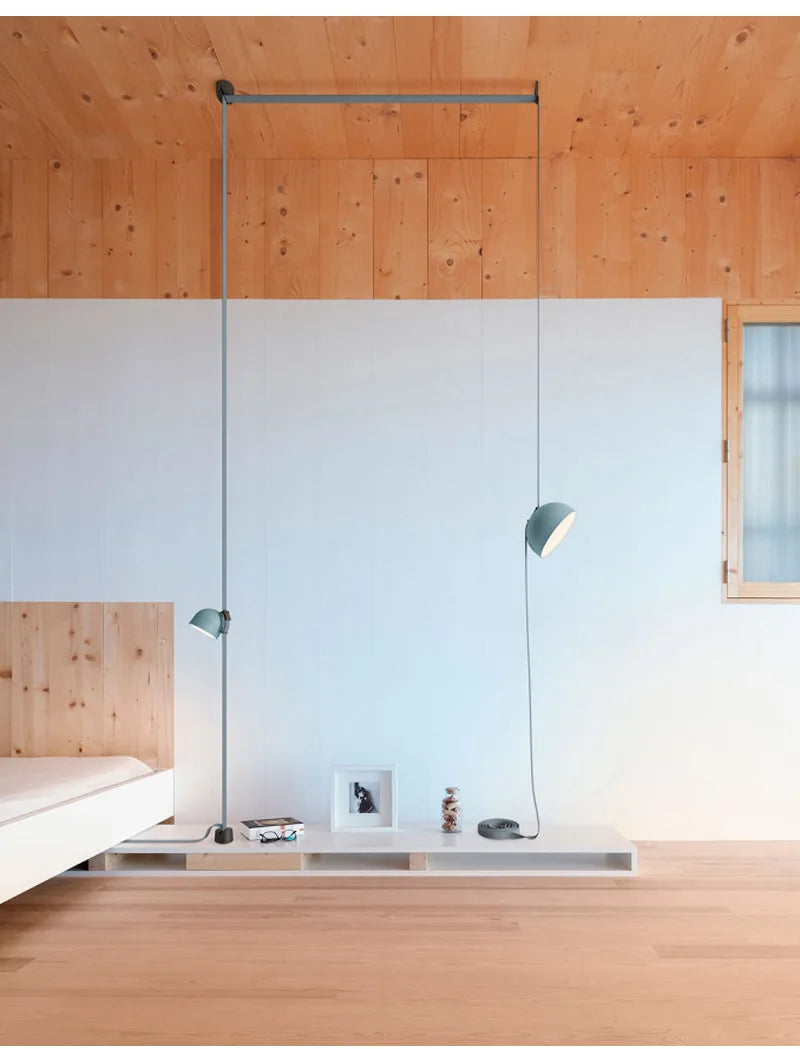 Teal-finished Hemisphere Suspension Light with adjustable ceiling track and leather strap detail, a refined statement pendant for serene Scandinavian-inspired bedrooms, by Domus Collective.