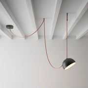 Hemisphere Suspension Light with matte black aluminum shade and terracotta leather cord, artisan-crafted modern pendant bringing sculptural warmth to minimalist interiors, by Domus Collective.