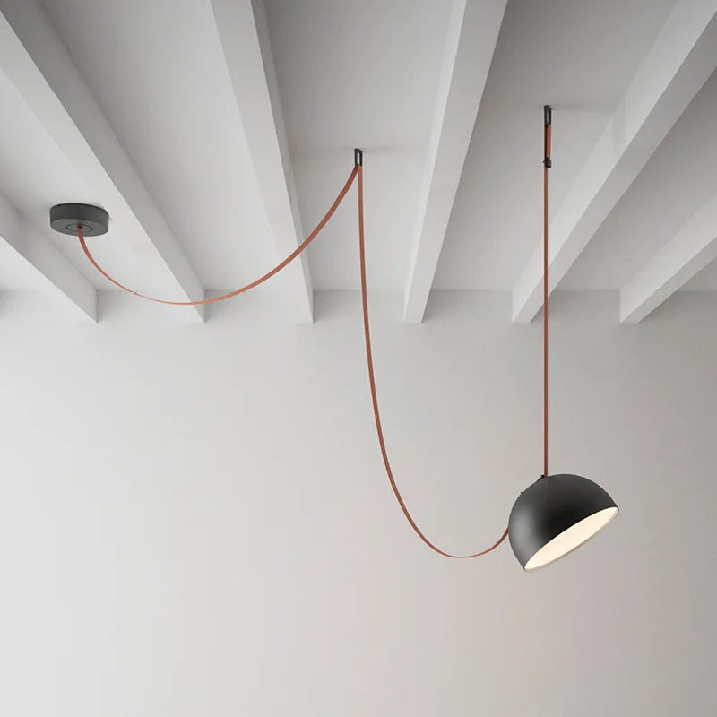 Hemisphere Suspension Light with matte black aluminum shade and terracotta leather cord, artisan-crafted modern pendant bringing sculptural warmth to minimalist interiors, by Domus Collective.