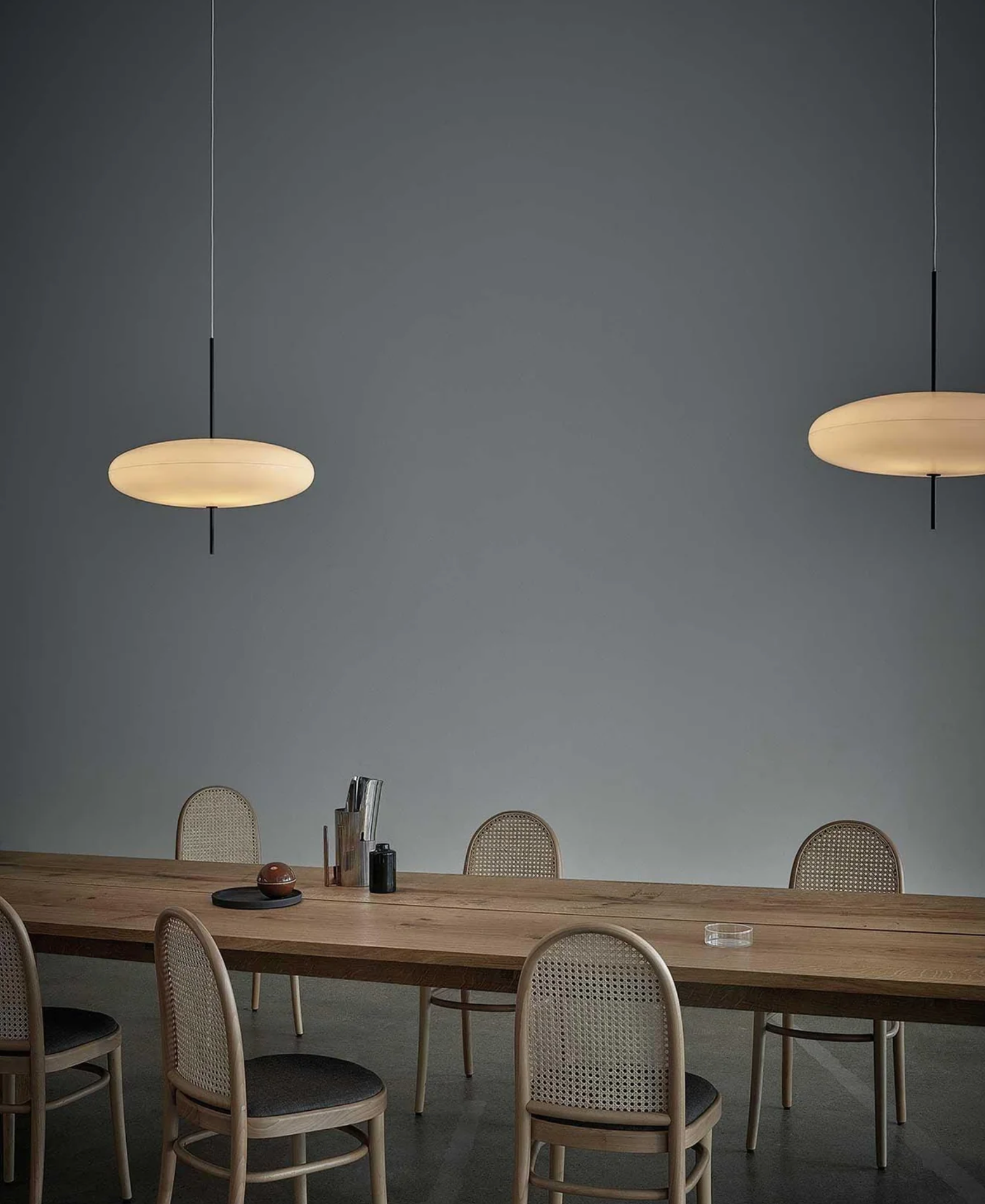 Hovering Cloud Pendant Light in white by Domus Collective, a modern sculptural ceiling light shaped like a soft floating cloud, suspended by thin wires over a timber dinning table.