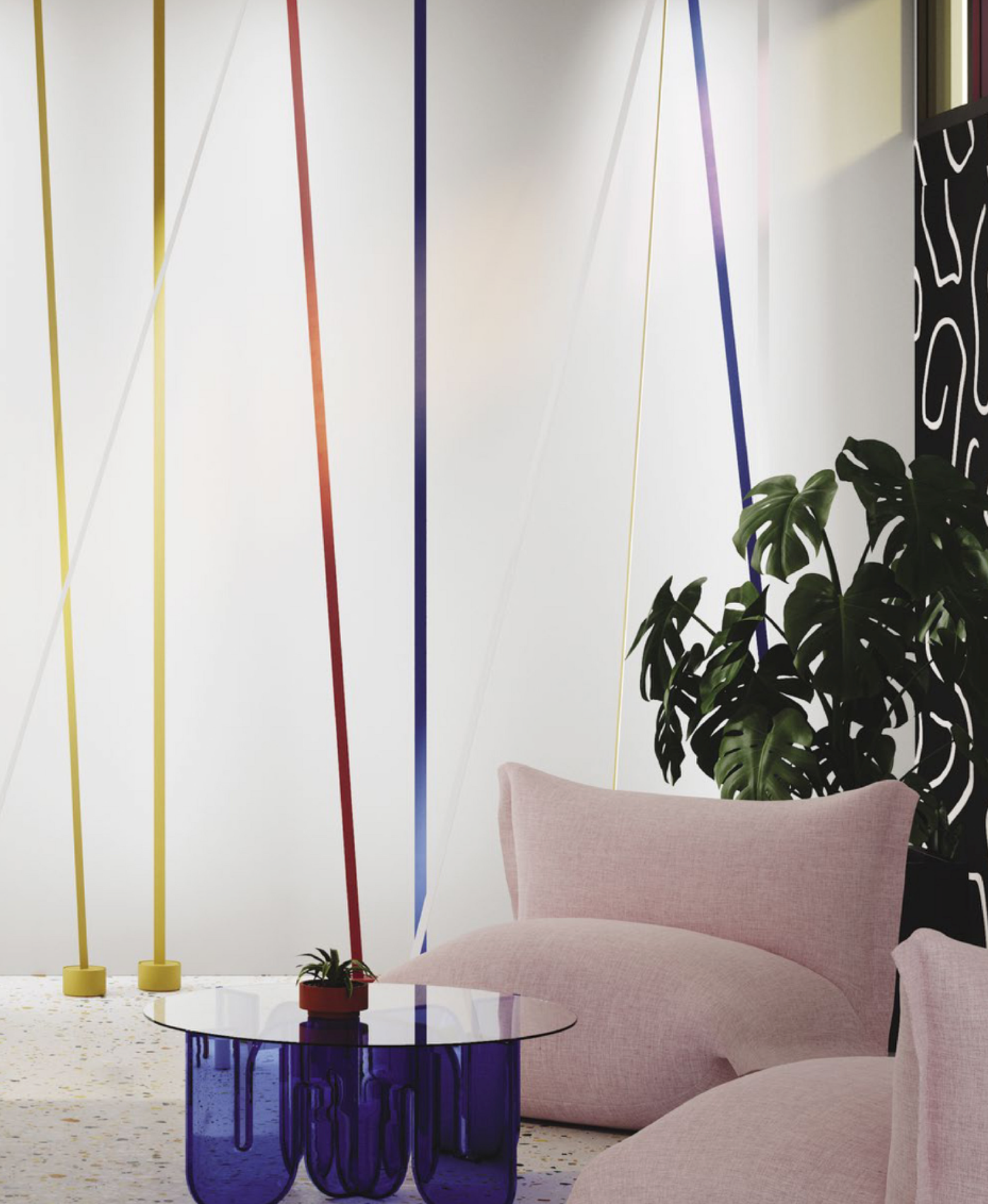 Illuminus Threads Suspension Light in yellow, orange, and blue descending vertically in a vibrant contemporary space with pink seating and colorful accents, delivering playful artistic illumination for modern interiors.