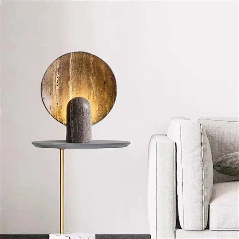 Jupiter Halo Table Lamp casting celestial ambient light on a contemporary side table, solid stone construction with circular halo disc and rounded pedestal base creating cosmic sophistication, by Domus Collective.