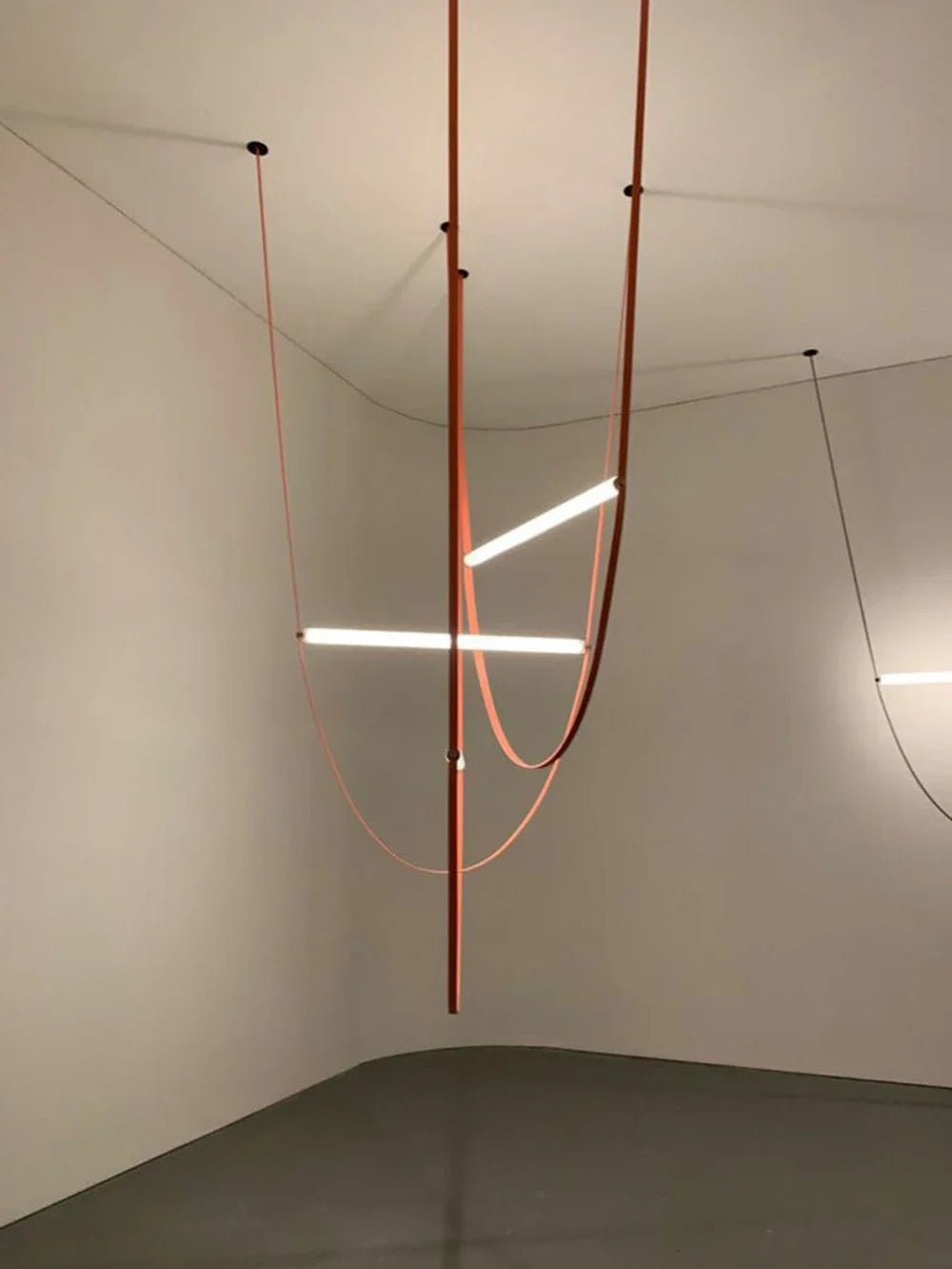 Dramatic Leather Trapeze Suspension Lights installation with terracotta and coral straps cascading from high ceiling, gallery-scale sculptural chandelier designed for statement architectural moments, by Domus Collective.