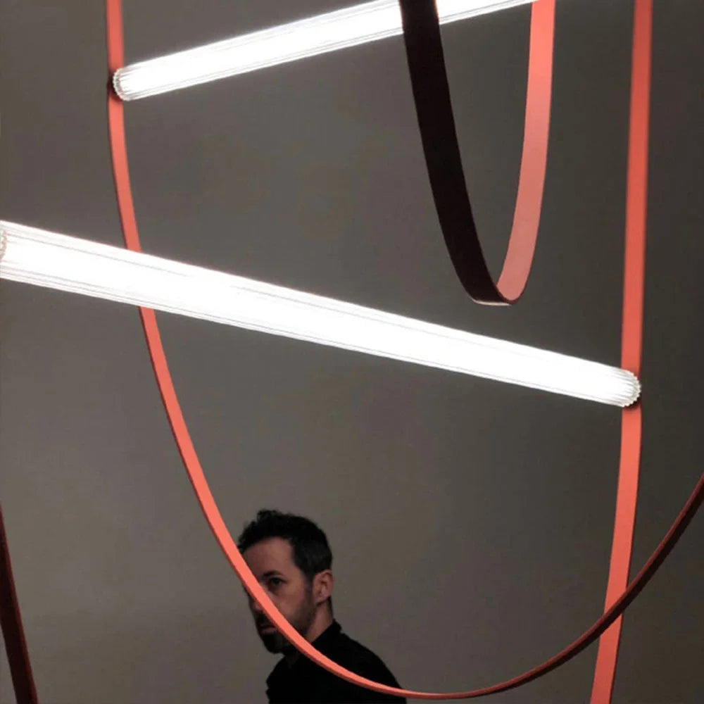 Close-up of Leather Trapeze Suspension Lights showing terracotta and burgundy leather straps with ribbed glass LED tubes, showcasing handcrafted material quality and sculptural design detail, by Domus Collective.