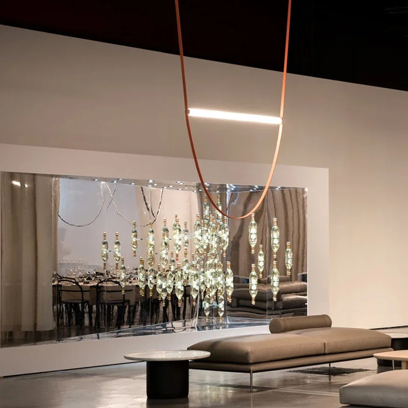 Leather Trapeze Suspension Light with single peach leather strap and linear LED element, refined minimalist fixture bringing gallery-worthy sophistication to designer showroom spaces, by Domus Collective.