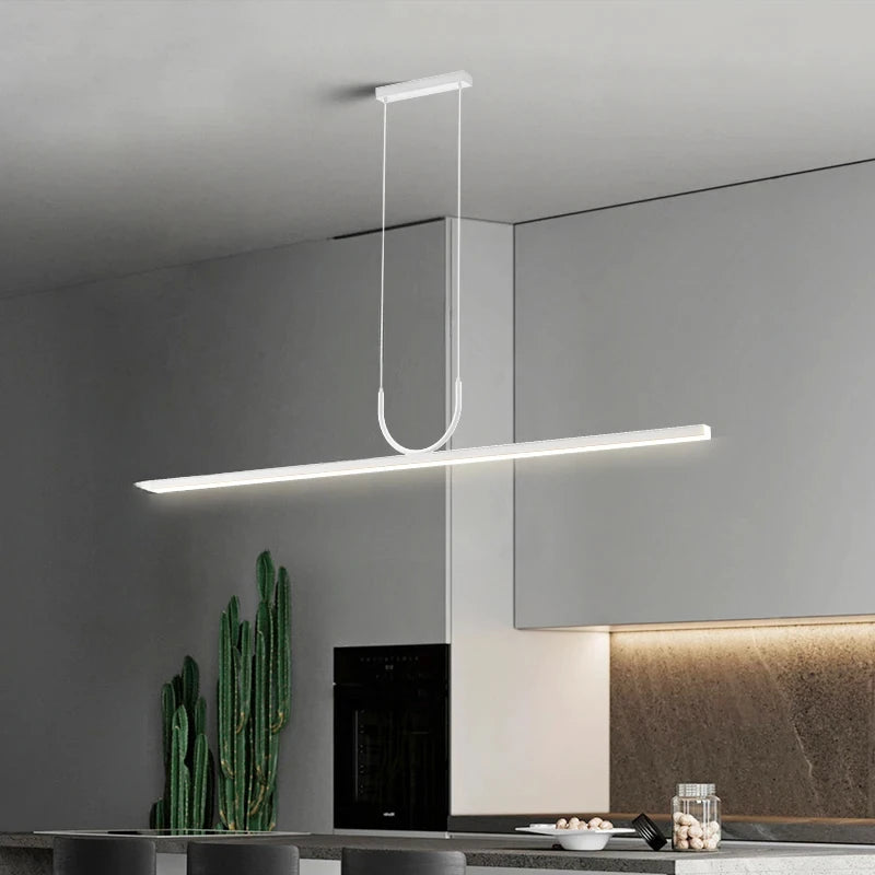 Domus Collective Linea Arc Pendant Light in crisp white finish suspended above a modern kitchen island, architectural linear form delivering sophisticated illumination.