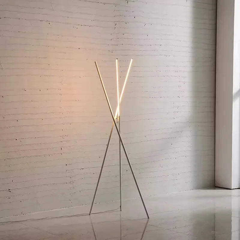 Minimalist Linear Tension Floor Lamp in white powder-coated metal, its intersecting lines and warm LED glow bringing refined modern elegance to contemporary interiors, by Domus Collective.