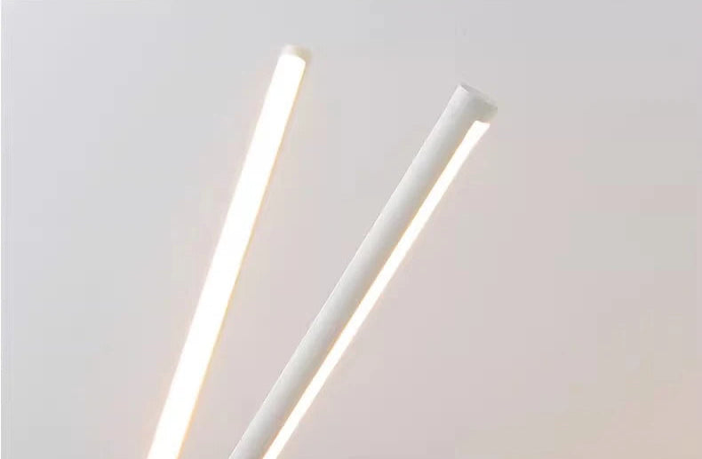 Close-up of the Linear Tension Floor Lamp's integrated LED light bars in warm white, revealing the seamless illumination along slender metal rods for a minimalist sanctuary aesthetic, by Domus Collective.