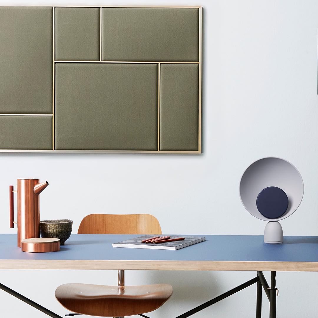 Grey Lunar Eclipse Table Lamp with navy accent disc styling a mid-century modern desk alongside copper accessories, bringing artistic sophistication to contemporary home office spaces, by Domus Collective.