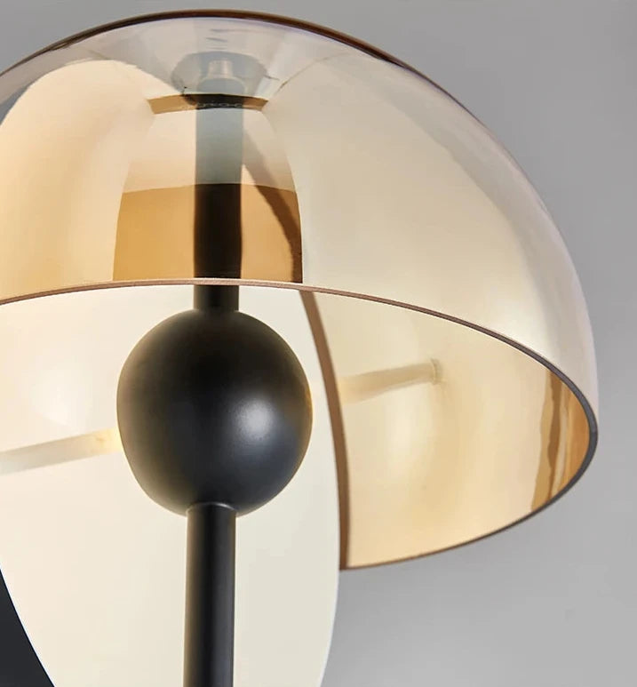 Detail of the Lunar Visor Floor Lamp showing layered amber glass dome construction with matte black central orb and stem junction, artisan crafted by Domus Collective.