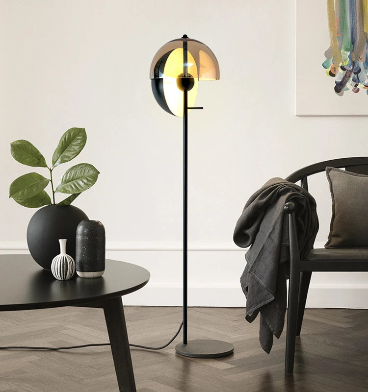 Lunar Visor Floor Lamp bringing warm sculptural presence to a Scandinavian-inspired living room with herringbone floors and modern furnishings, statement piece by Domus Collective.
