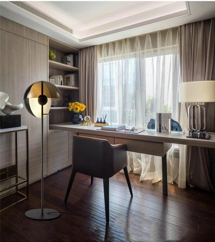 Lunar Visor Floor Lamp adding refined ambient lighting to a luxurious home office with rich wood tones and tailored drapery, elegant contemporary design by Domus Collective.