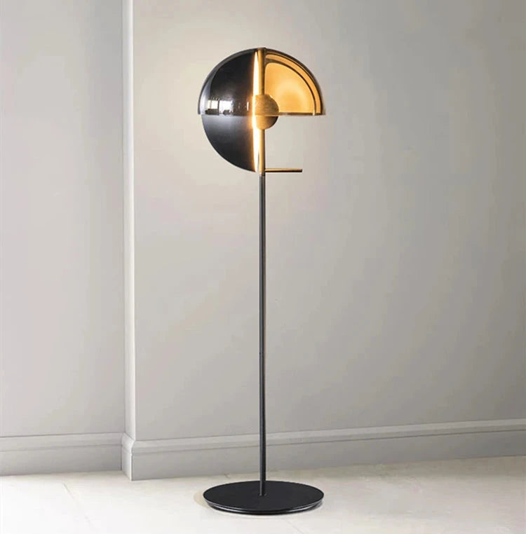 Lunar Visor Floor Lamp featuring polished chrome upper dome with warm amber lower hemisphere creating dramatic ambient glow, architectural lighting by Domus Collective.