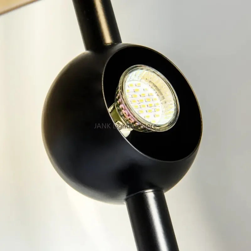 Detail of the Lunar Visor lamp's integrated LED module housed within its matte black spherical light source, energy-efficient design by Domus Collective.