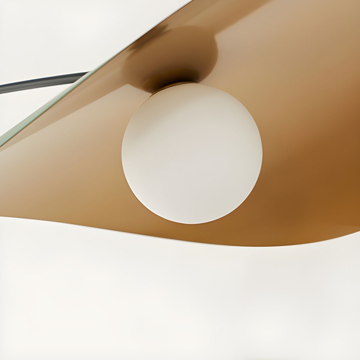 Close-up of the Papilla Pendant Light's shade interior in warm caramel gold finish with central frosted glass globe, demonstrating the premium material quality and ambient light diffusion.