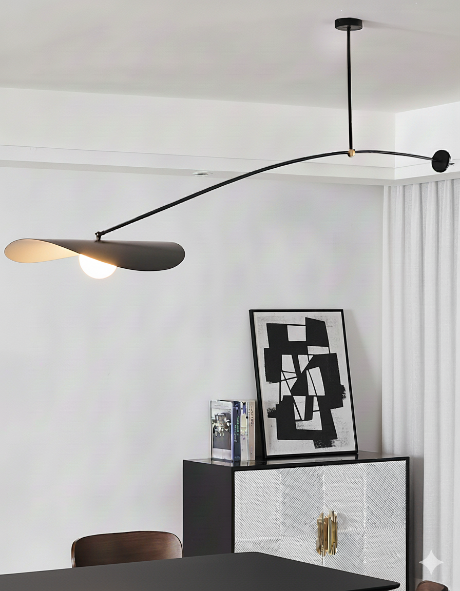 Papilla Pendant Light in matte black with nature-inspired overlapping shades and circular counterweight disc, providing artistic illumination above a modern dining area by Domus Collective.