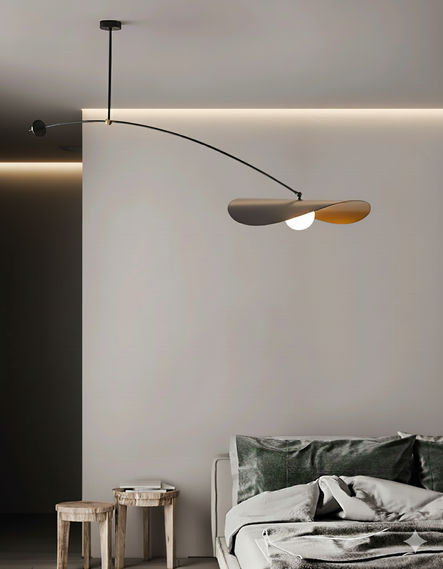 Papilla Pendant Light with sweeping curved arm and butterfly-inspired dual shades in black with warm gold interior, suspended gracefully over a contemporary bedroom setting by Domus Collective.
