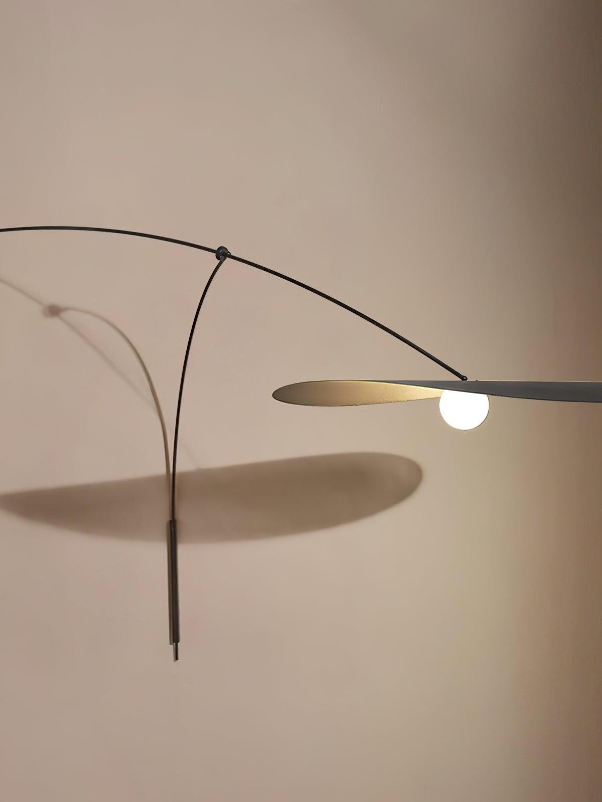 Detail of the Papilla Wall Lamp's butterfly shade assembly showing layered black and gold metal petals with frosted globe bulb, highlighting the precision craftsmanship by Domus Collective.
