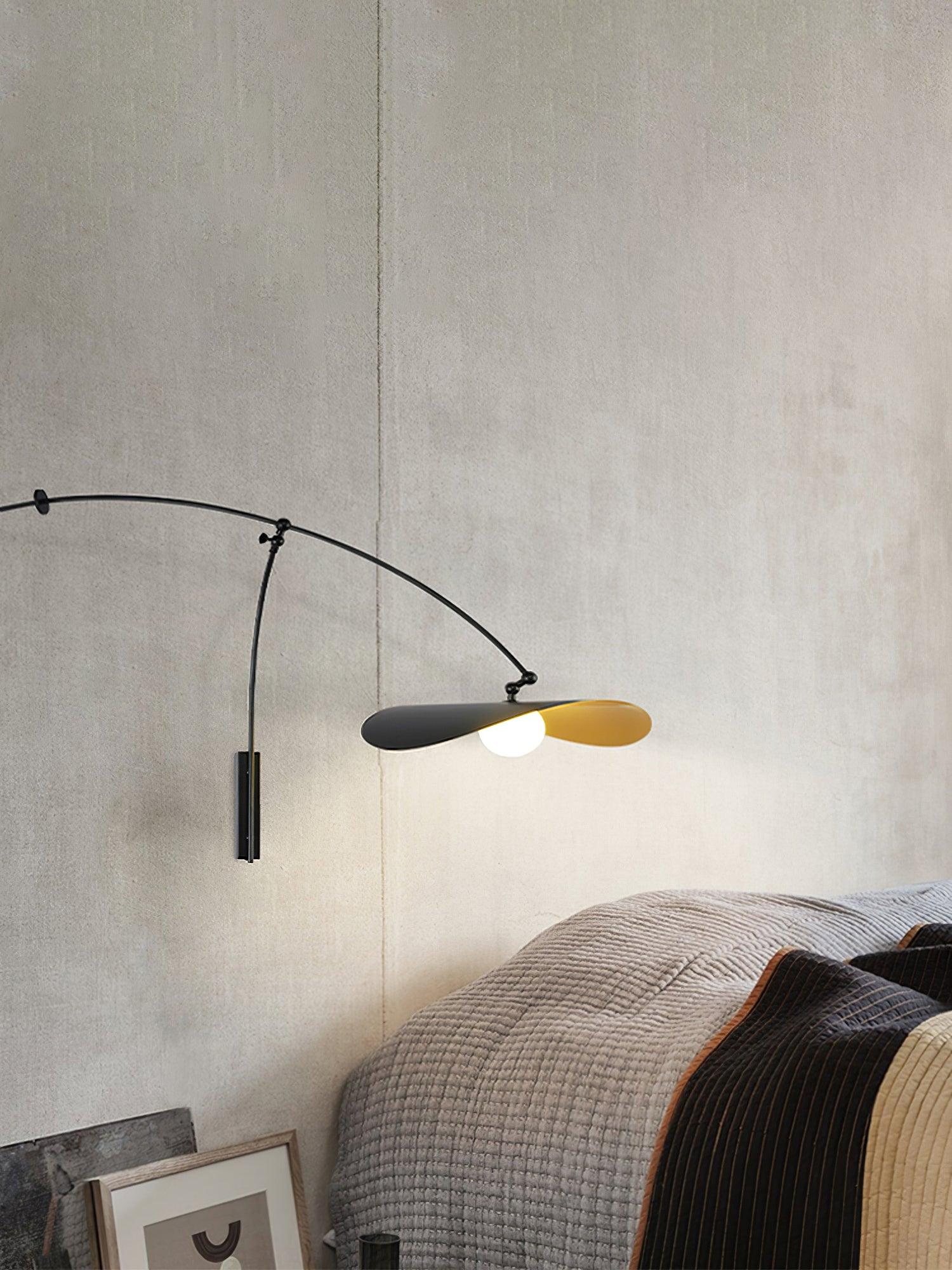 Sculptural swing arm wall sconce featuring butterfly-inspired double shade design in black and gold finish, the Papilla Wall Lamp creates intimate bedside illumination with artistic flair.