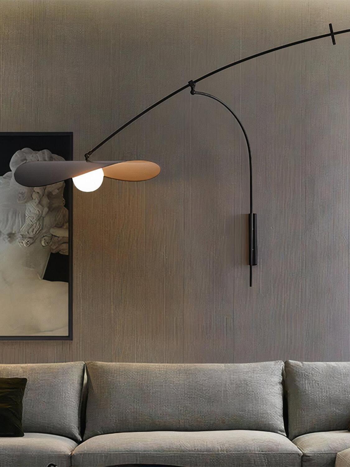 Papilla Wall Lamp with extended arc arm and overlapping organic shades in black and terracotta, mounted above a textured velvet sofa to create atmospheric living room lighting by Domus Collective.