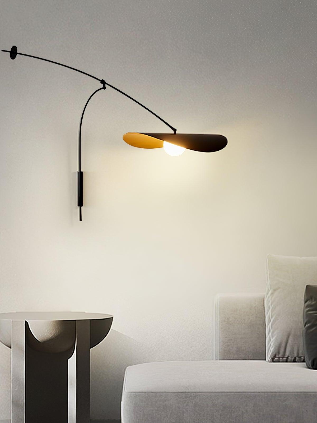 Papilla Wall Lamp with sweeping curved arm and dual organic shades in matte black exterior with golden interior, casting warm ambient light in contemporary living spaces by Domus Collective.
