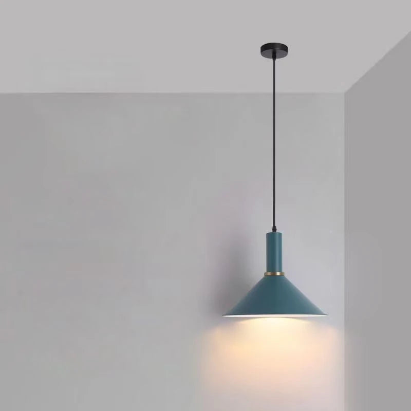 Bold teal conical shade accented with brass hardware adds mid-century modern flair to dining spaces in this Pastel Rainbow Pendant Light, by Domus Collective.