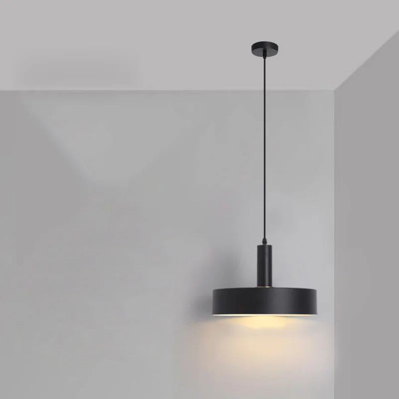 
Sleek matte black drum with cylindrical stem offers modern sophistication for minimalist contemporary spaces in this Pastel Rainbow Pendant Light, by Domus Collective.