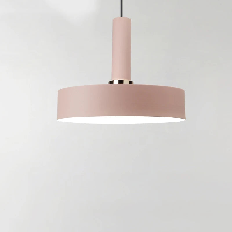 Elegant dusty rose drum with polished brass ring creates soft romantic glow for contemporary dining rooms in this Pastel Rainbow Pendant Light, by Domus Collective.