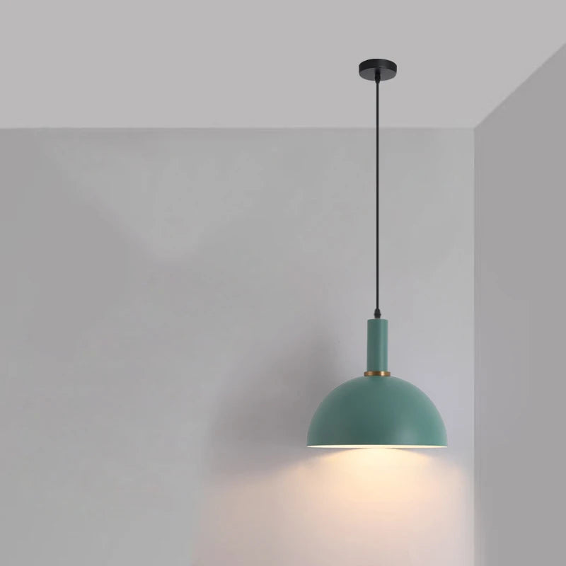 Rounded sage green dome with brass collar brings organic calm to Scandinavian-inspired living spaces in this Pastel Rainbow Pendant Light, by Domus Collective.