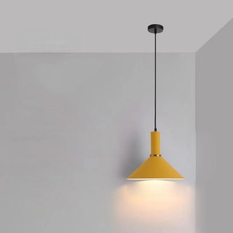 Mustard yellow conical shade with brass detail defines this Pastel Rainbow Pendant Light, a cheerful matte metal fixture designed to cast warm focused light in contemporary kitchens, by Domus Collective.