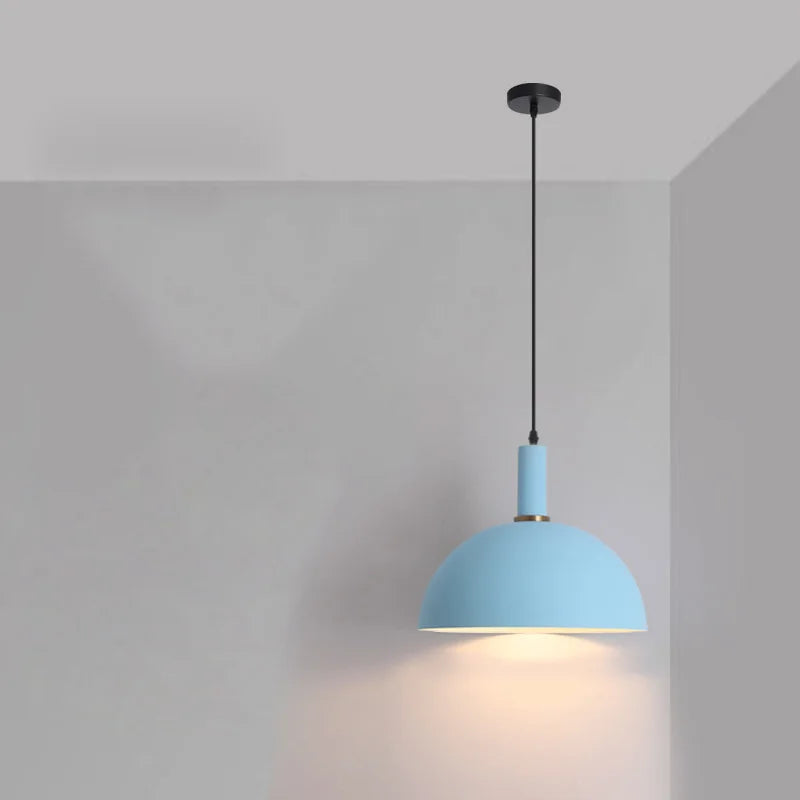 A sky blue dome shade with brass accent and white interior makes this Pastel Rainbow Pendant Light a playful addition for minimalist children's rooms, by Domus Collective.