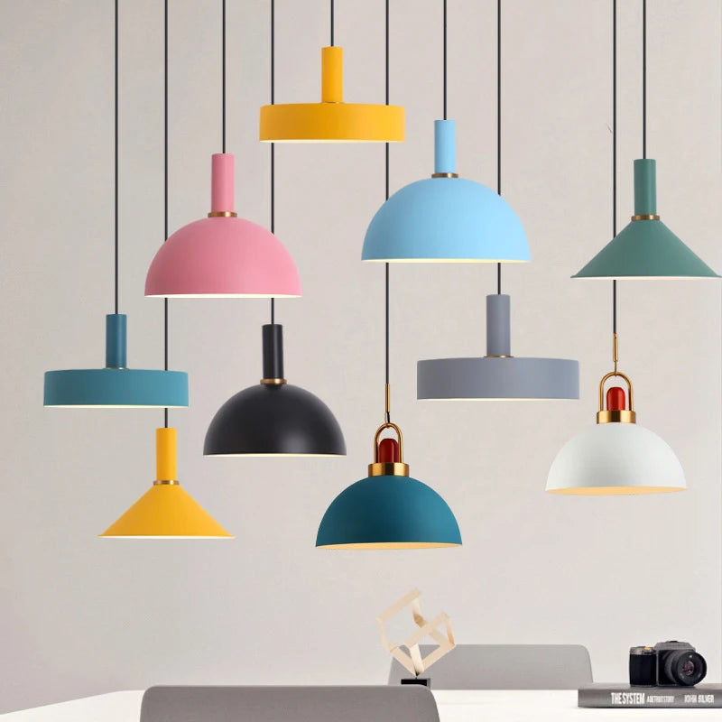 A curated display of the Pastel Rainbow Pendant Light collection featuring playful shades in mustard yellow, blush pink, sky blue, teal, and soft gray, each with brass accents for cheerful Scandinavian-inspired interiors, by Domus Collective.