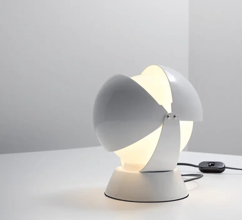 White lacquered PikaGlow Table Lamp with adjustable spherical shade tilted to direct warm light, featuring an integrated cord switch for effortless illumination control, by Domus Collective.