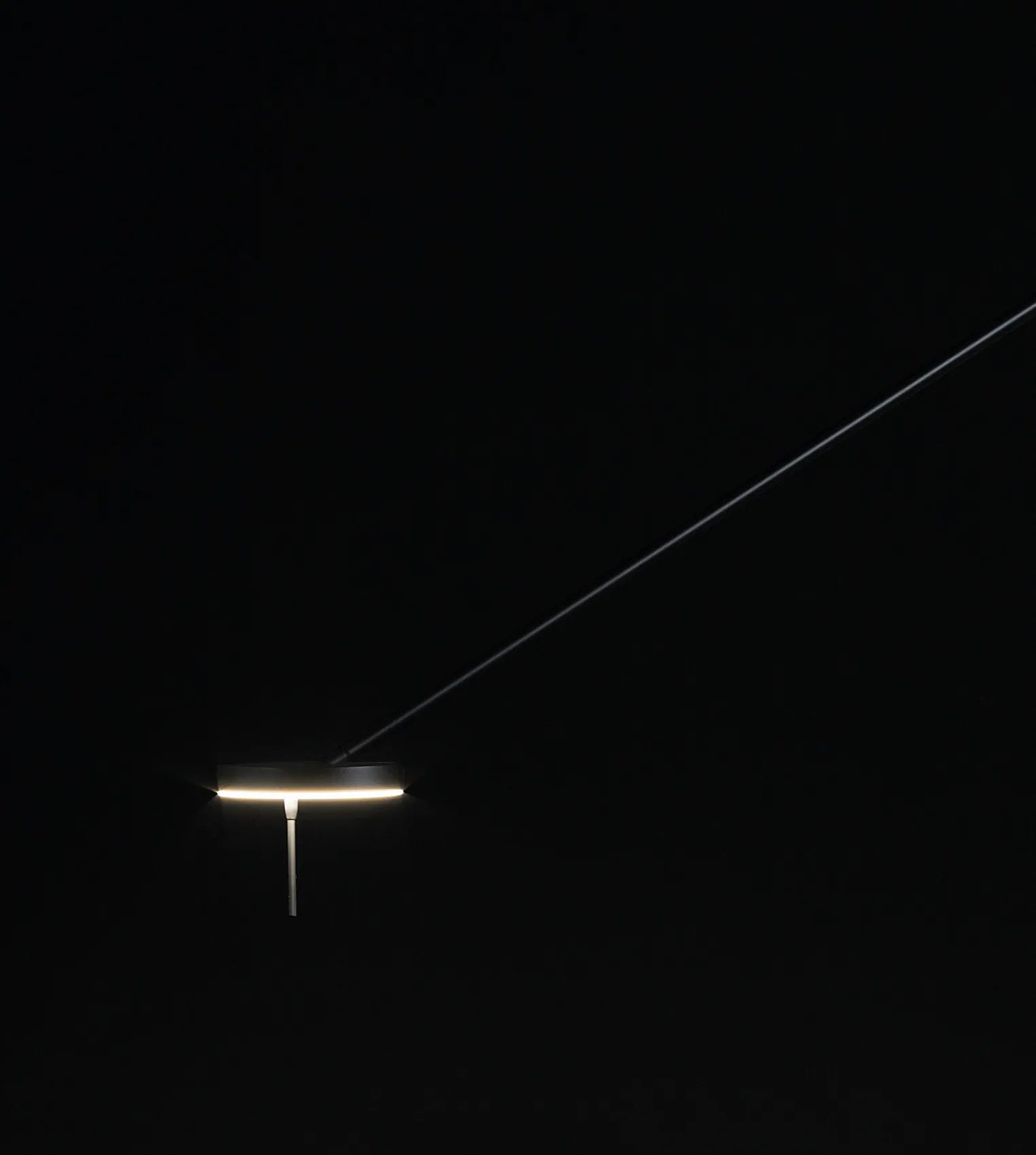 
Refined Span Wall Light illuminated against a dark background, highlighting the warm glow of the circular LED head and slender cantilever arm that define this sculptural fixture by Domus Collective.
