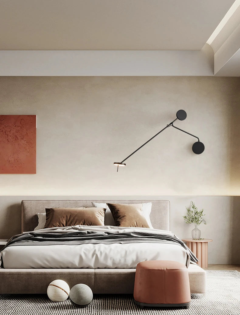 Designer swing arm wall sconce in matte black finish positioned above a contemporary bed, the Refined Span Wall Light delivers adjustable focused lighting with clean architectural lines.