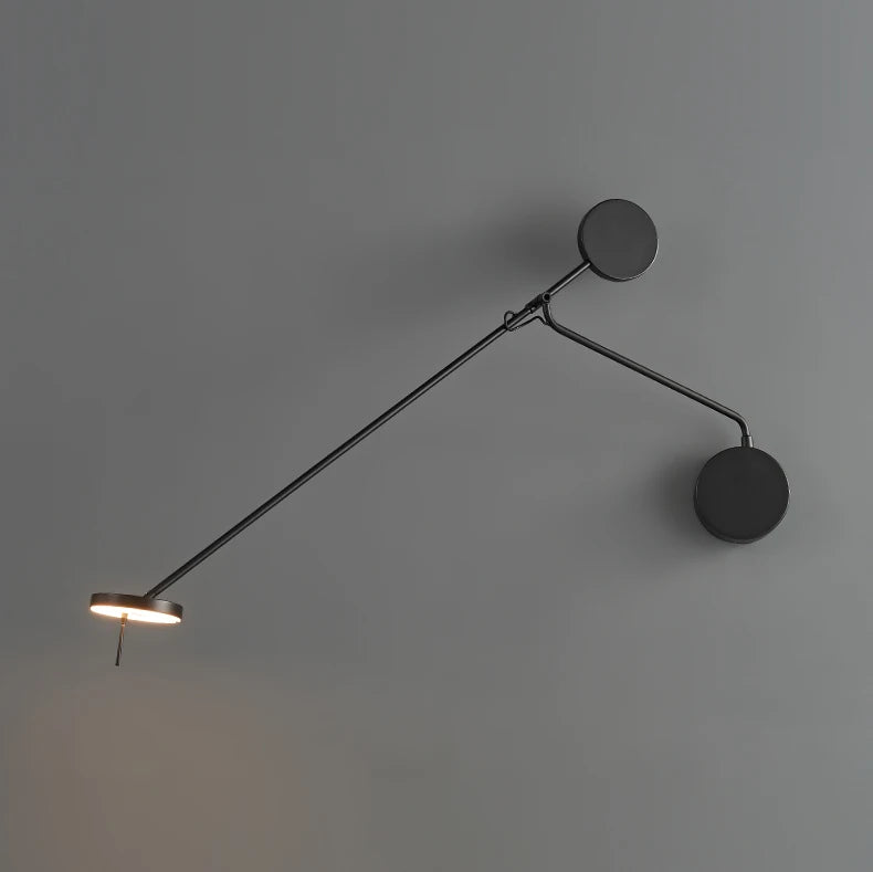 Full extension view of the Refined Span Wall Light displaying the warm-toned LED disc head, precision pivot joint, and circular wall mount in sophisticated black metal finish.